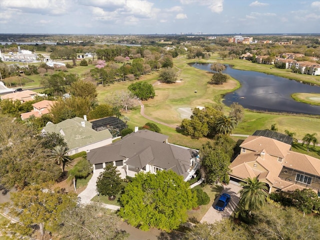 drone / aerial view with view of golf course and a water view