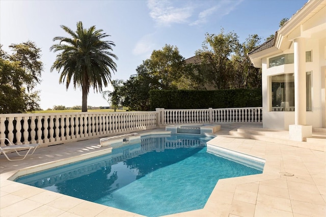 view of pool featuring a pool with connected hot tub and a patio area