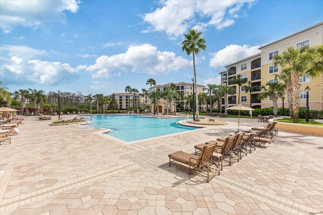 community pool with a patio area