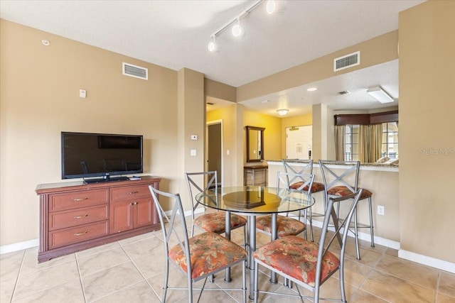 dining room with light tile patterned floors, baseboards, and visible vents