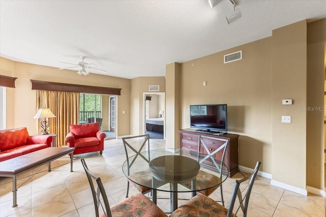 dining room featuring visible vents, ceiling fan, baseboards, and light tile patterned floors