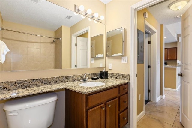 full bathroom with visible vents, toilet, a textured ceiling, vanity, and tile patterned flooring