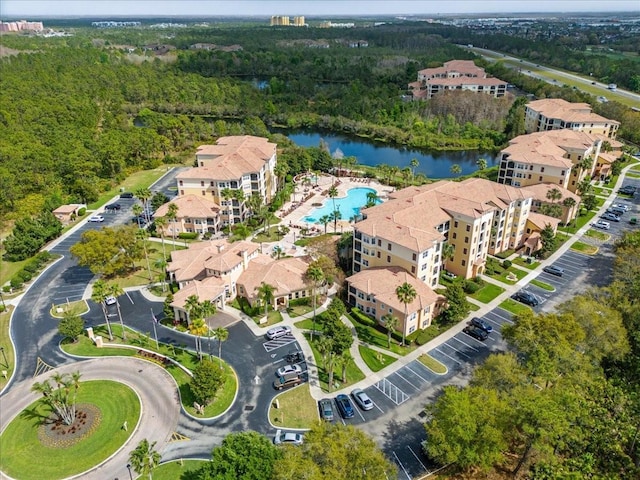 birds eye view of property featuring a water view and a forest view