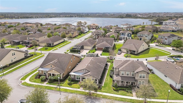 birds eye view of property with a residential view and a water view