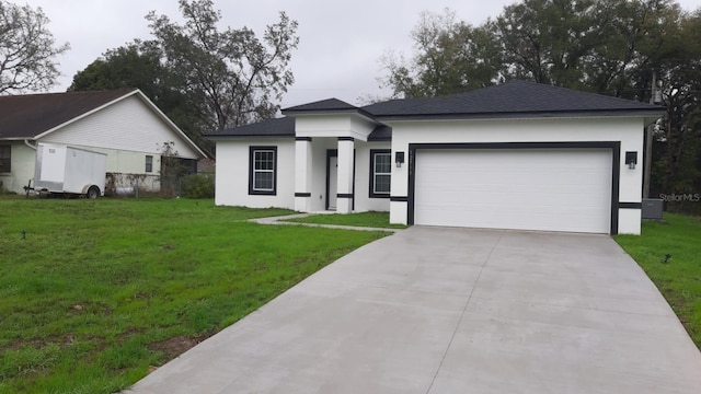 view of front of property featuring an attached garage, a front lawn, and stucco siding