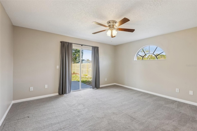 unfurnished room featuring baseboards, a ceiling fan, carpet flooring, and a textured ceiling