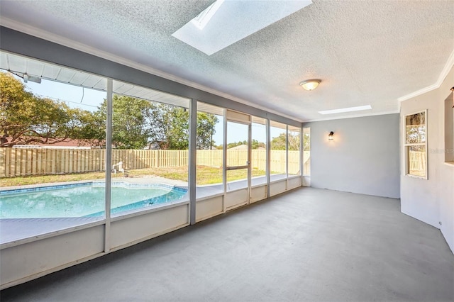 unfurnished sunroom featuring a skylight