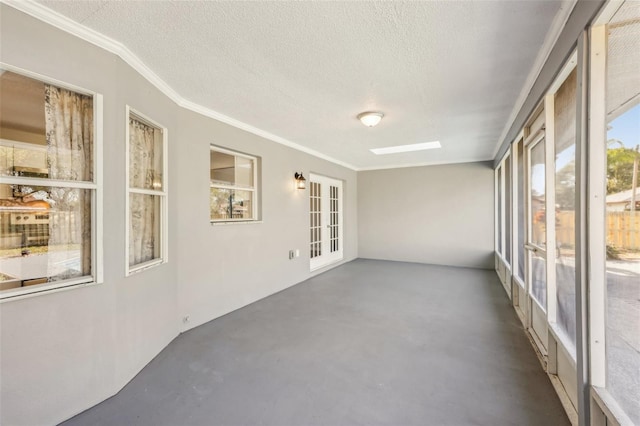 unfurnished sunroom featuring a skylight