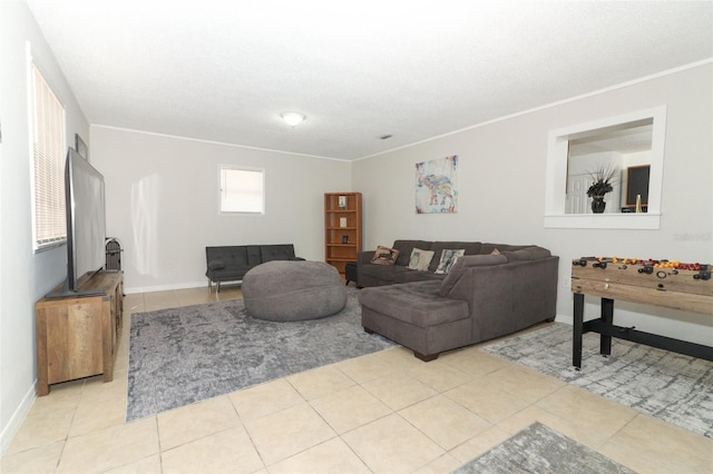 living room featuring ornamental molding, baseboards, and light tile patterned floors