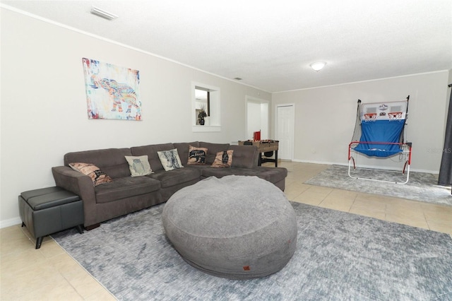 tiled living room with baseboards, visible vents, and ornamental molding