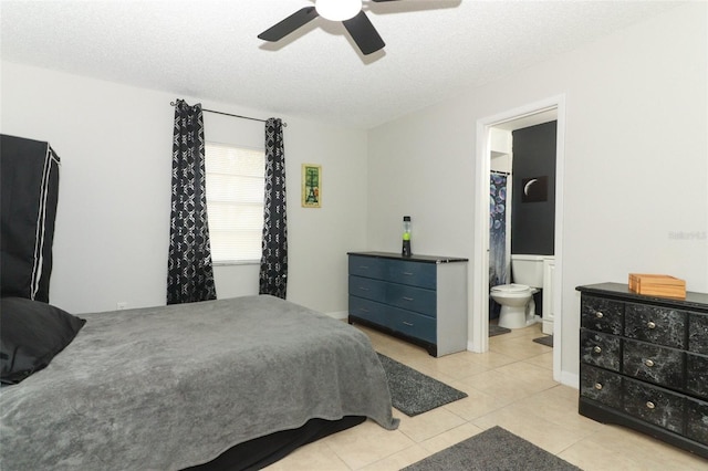 tiled bedroom with a ceiling fan, a textured ceiling, and ensuite bathroom