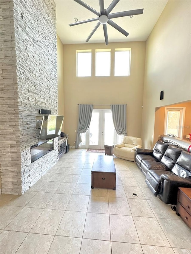 living room featuring light tile patterned flooring, french doors, and a ceiling fan