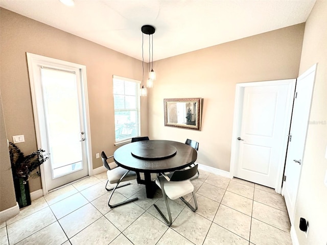 dining room with light tile patterned flooring and baseboards