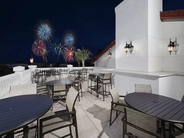 patio at twilight featuring outdoor dining space