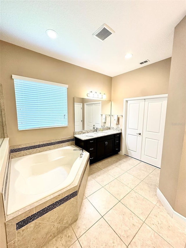 bathroom with a bath, visible vents, and vanity