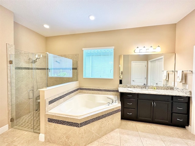 full bath with vanity, a garden tub, a stall shower, and tile patterned flooring