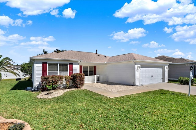 ranch-style home with a garage, driveway, and a front lawn