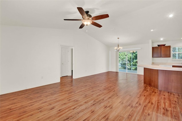 unfurnished living room featuring light wood-style floors, lofted ceiling, and ceiling fan with notable chandelier