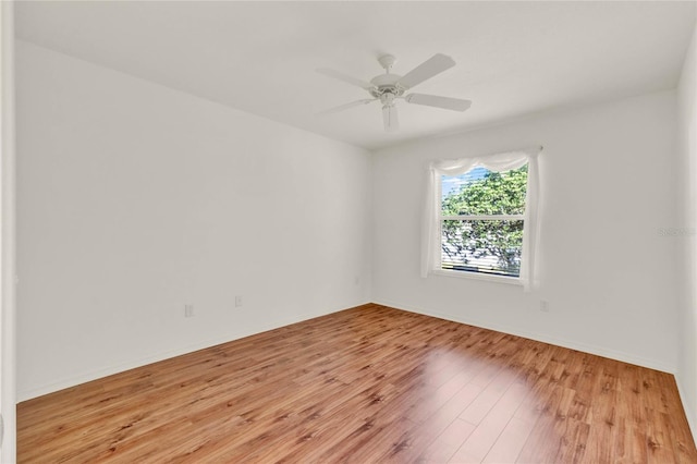 unfurnished room with ceiling fan, baseboards, and wood finished floors