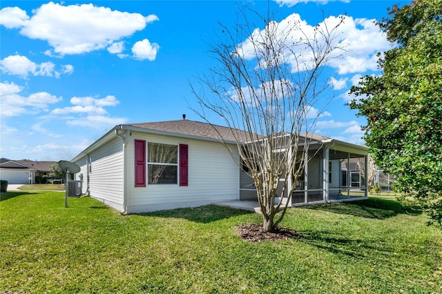 view of property exterior with a sunroom, a patio area, a yard, and central AC unit