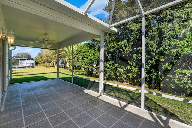 unfurnished sunroom featuring ceiling fan