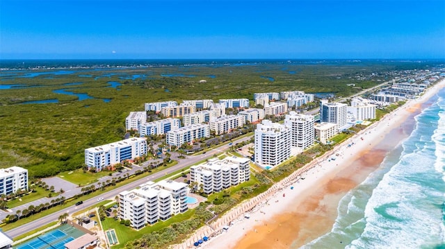 aerial view featuring a water view, a view of the beach, and a city view