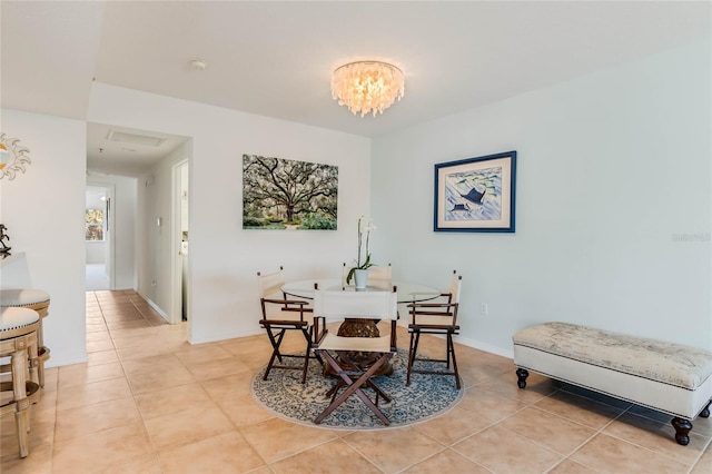 dining room featuring light tile patterned floors, a chandelier, and baseboards