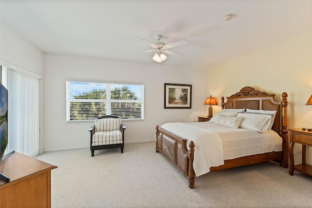 bedroom with a ceiling fan, light colored carpet, and baseboards