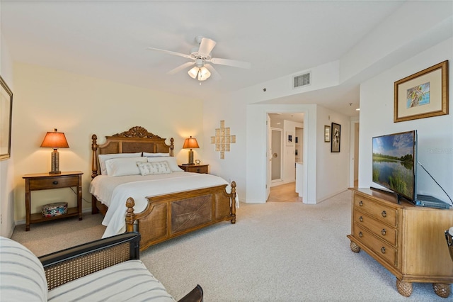 bedroom with a ceiling fan, light colored carpet, visible vents, and baseboards