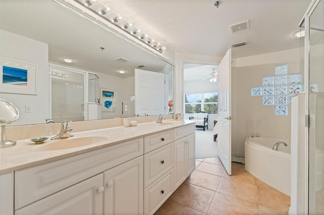 bathroom with double vanity, visible vents, ceiling fan, tile patterned floors, and a sink