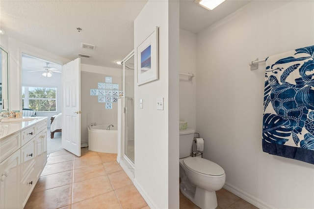 bathroom featuring a stall shower, tile patterned flooring, a bath, and vanity