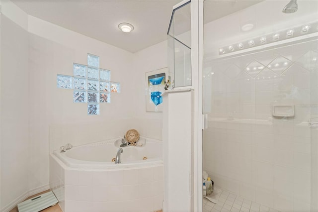 bathroom featuring a jetted tub and a shower stall