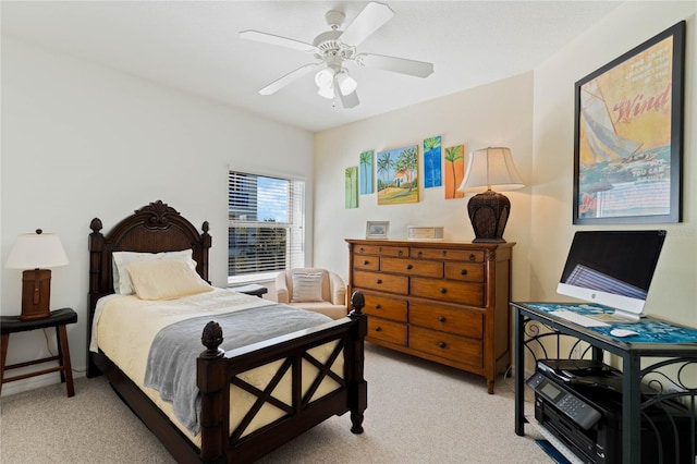 bedroom with light colored carpet, ceiling fan, and baseboards