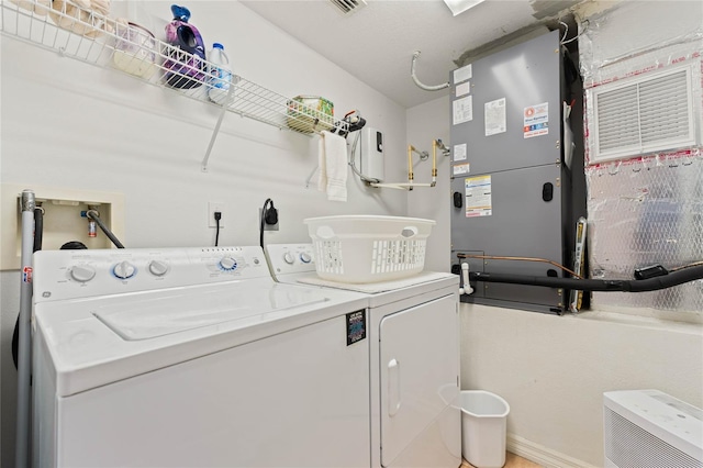 laundry room featuring washer and dryer, laundry area, and visible vents