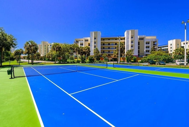 5300 S Atlantic Ave Unit 7-301, New Smyrna Beach, FL 32169 - view of tennis court with fence and community basketball court
