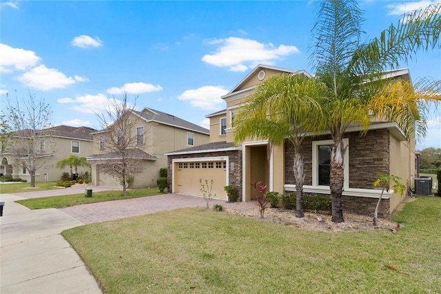 view of front of home featuring stone siding, decorative driveway, and a front lawn