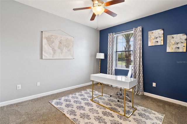 carpeted office featuring baseboards and ceiling fan