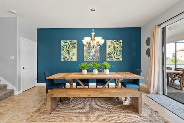 dining space featuring light tile patterned floors, stairway, baseboards, and a notable chandelier