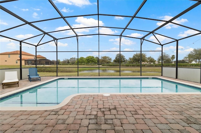 pool with glass enclosure and a patio