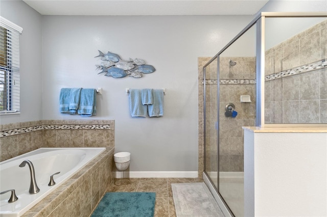 full bathroom with a shower stall, a garden tub, baseboards, and tile patterned floors