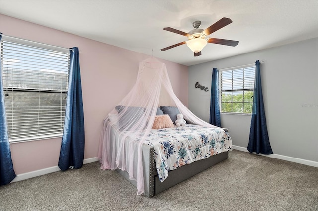 carpeted bedroom featuring baseboards and a ceiling fan