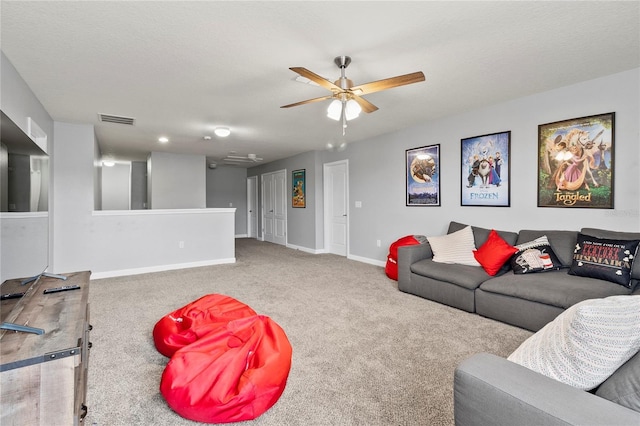 carpeted living room featuring visible vents, a ceiling fan, and baseboards