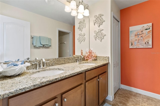 full bathroom featuring a sink, an inviting chandelier, double vanity, and tile patterned floors