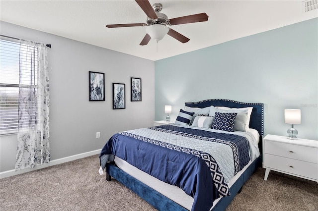 carpeted bedroom with visible vents, a ceiling fan, and baseboards