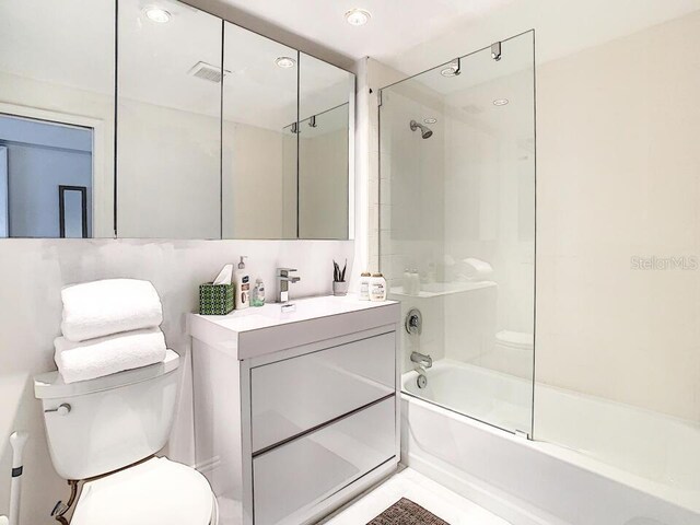 bathroom featuring visible vents, bath / shower combo with glass door, vanity, and toilet