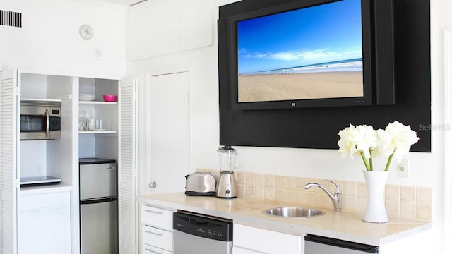 kitchen with white cabinetry, visible vents, stainless steel appliances, and a sink