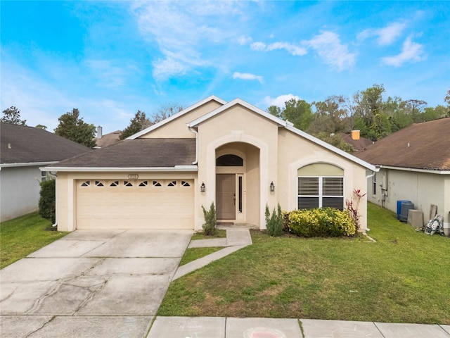 view of front of property with an attached garage, concrete driveway, a front yard, and stucco siding