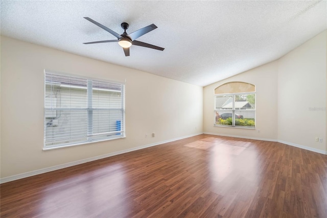 unfurnished room featuring a textured ceiling, a ceiling fan, vaulted ceiling, and wood finished floors