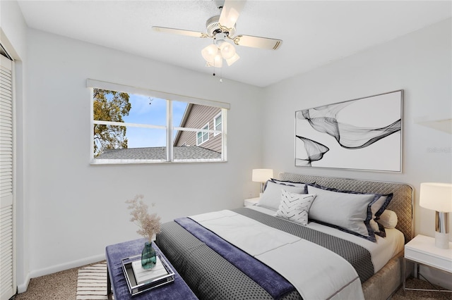 bedroom with a closet, carpet, a ceiling fan, and baseboards