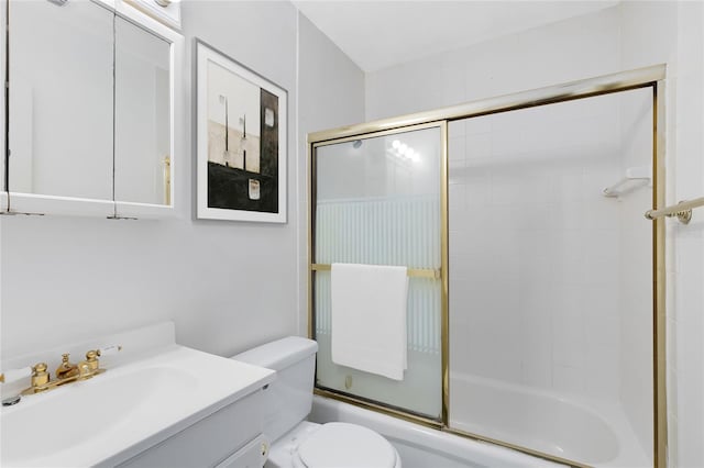 bathroom with toilet, combined bath / shower with glass door, and vanity